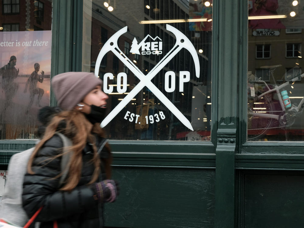A pedestrian walks by REI's flagship store in New York, where last year workers formed the company's first union.