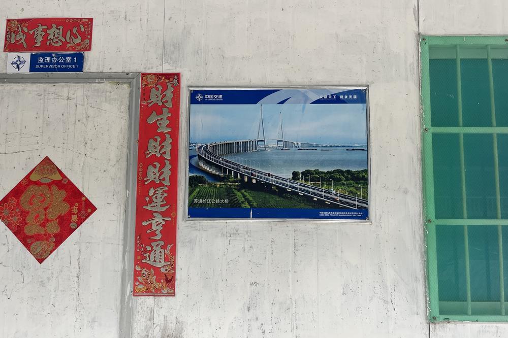 A poster depicting a mock-up of the finished rail line outside a local office of China Communications Construction Co.
