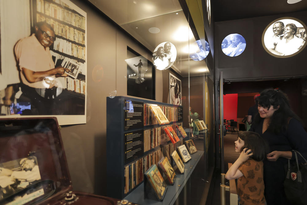 Patrons browse the display cases at the new Armstrong Center, featuring selections from the artist's massive archive.