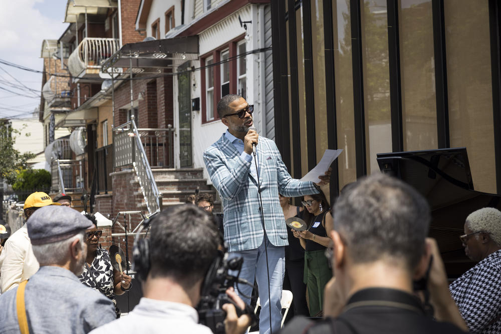 Jason Moran speaks at the opening of the Louis Armstrong Center. The pianist curated the museum's inaugural exhibition.