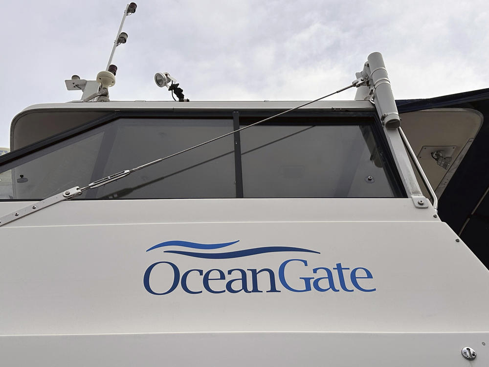 OceanGate says it's pausing its commercial and exploration operations. Its CEO, Stockton Rush, was among the five people killed when the company's Titan submersible imploded in June. Here, the OceanGate logo is seen on a boat parked near the company's offices in Everett, Washington.