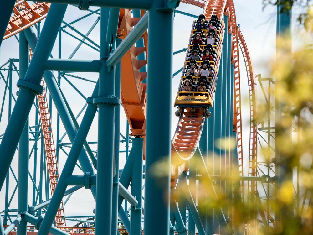 Visitors ride the roller coaster Scream at the Six Flags Magic Mountain theme park in Valencia, Calif., in 2021.