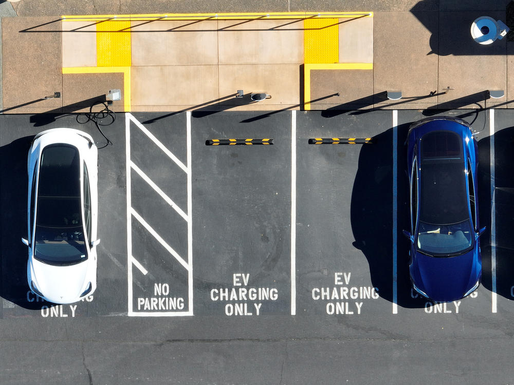 Tesla vehicles recharge in February in Corte Madera, Calif. The government wants to accelerate the transition to electric vehicle, but how fast the country can actually move is being hotly debated.