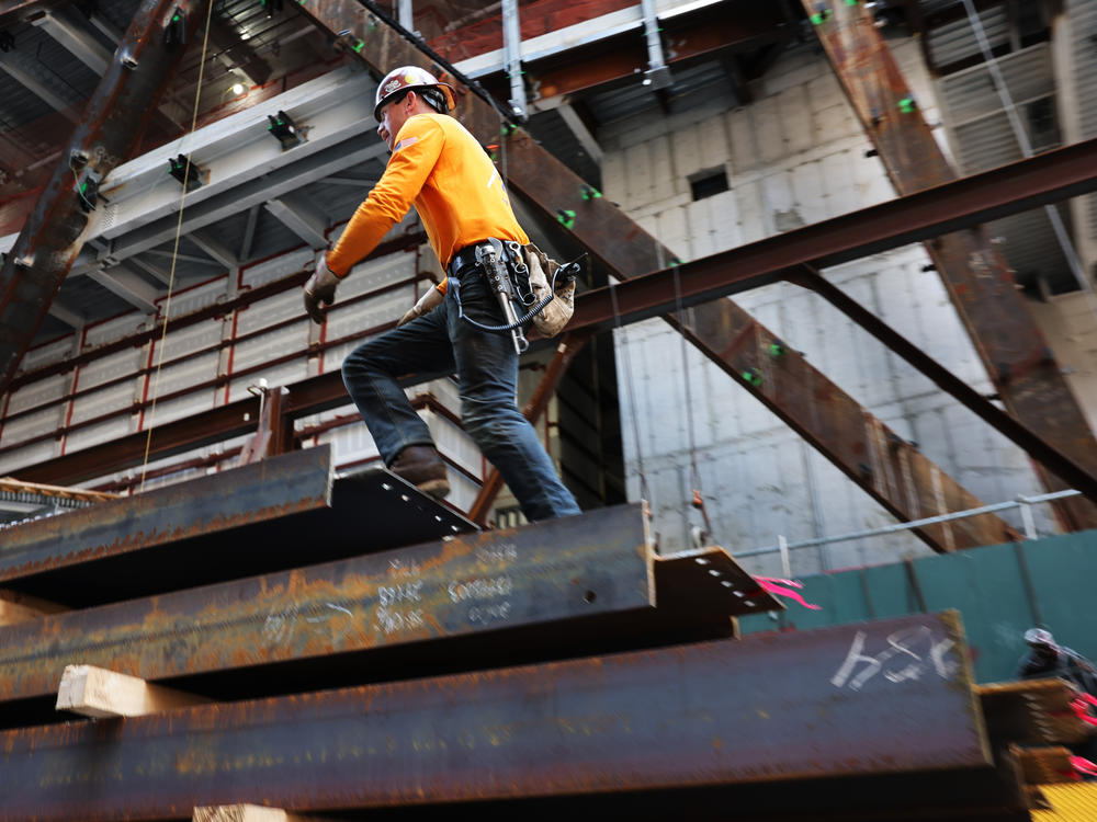 Construction workers prepare steel for a crane at construction site in New York City on May 18, 2023.