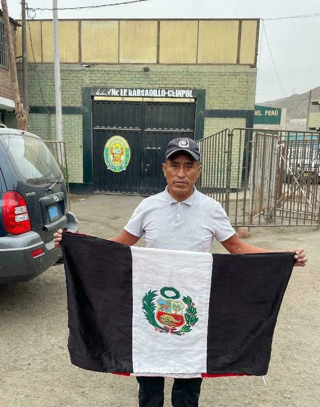 A supporter of jailed Peruvian former President Pedro Castillo at the front gate of Barbadillo prison, where Castillo is being held on charges that he tried to seize authoritarian powers last December.