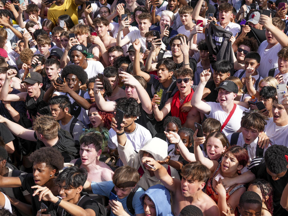 Fans react as KSI and Logan Paul arrive to promote an energy drink on an open top bus, traveling through London in June 2022.