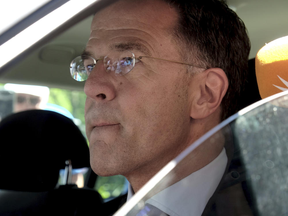 Dutch Prime Minister Mark Rutte sits in a car as he leaves Palace Huis ten Bosch in The Hague, Netherlands, Saturday, July 8, 2023 after he informed King Willem-Alexander that his coalition government has resigned.