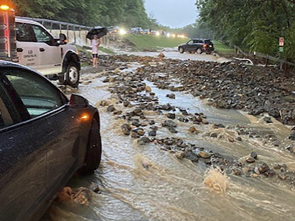 Vehicles come to a standstill near a washed-out and flooded portion of the Palisades Parkway just beyond the traffic circle off the Bear Mountain Bridge, Sunday, July 9, 2023, in Orange County, N.Y.