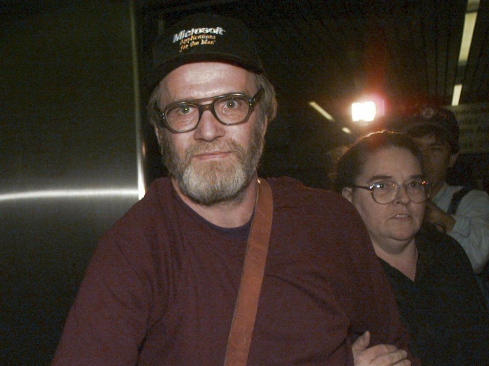 James Lewis is shown being escorted through Boston's Logan Airport, Friday Oct. 13, 1995, after being released from the Federal Correctional Institution in Oklahoma.