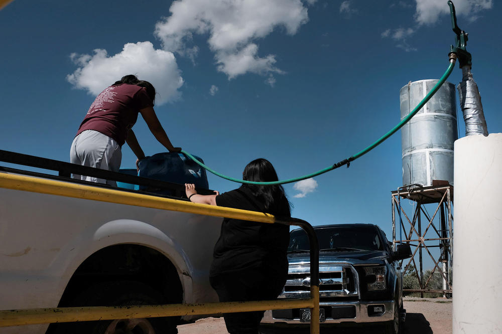 Women who belong to the Navajo Nation fill up their family's water containers. Parts of the reservation still lack running water and the tribe has been pushing for rights to the Colorado River for decades.