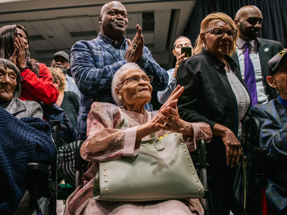 (L-R) Survivors Lessie Benningfield Randle, Viola Fletcher, and Hughes Van Ellis sing together at the conclusion of a rally during commemorations of the 100th anniversary of the Tulsa Race Massacre in 2021.