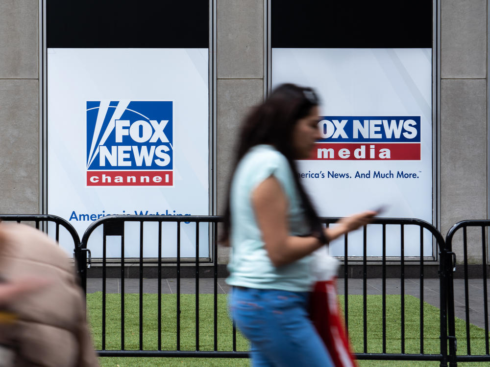 A man who was at the Jan. 6 attack on the U.S. Capitol has sued Fox News for defamation. Here, a woman walks by the Fox News headquarters in New York in April.