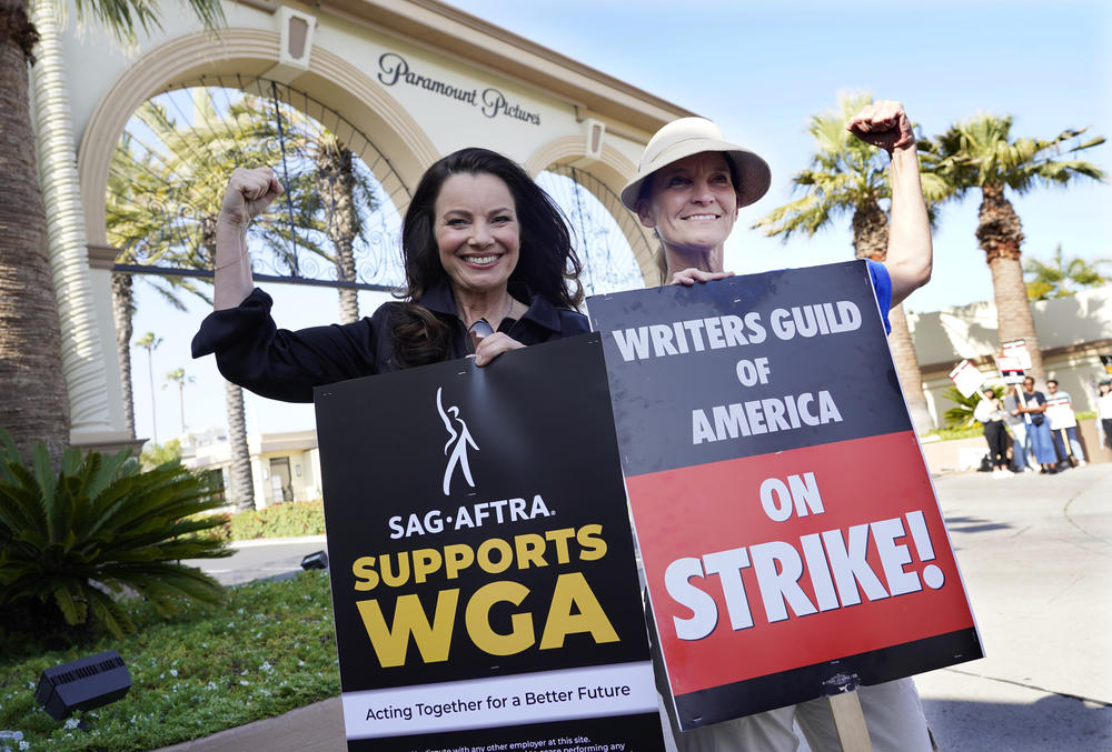 Fran Drescher, left, president of SAG-AFTRA, and Meredith Stiehm, president of Writers Guild of America West, pose together during a rally outside Paramount Pictures studio, Monday, May 8, 2023, in Los Angeles.