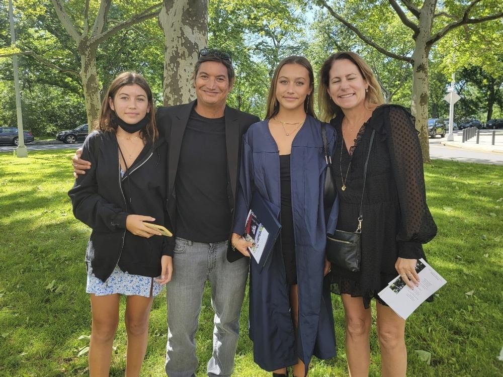 This June 2022 photo provided by Dr. John Jones shows Mikala Jones in New York with his daughter Violet, left, and on the right, daughter Bella and wife Emma Brereton.