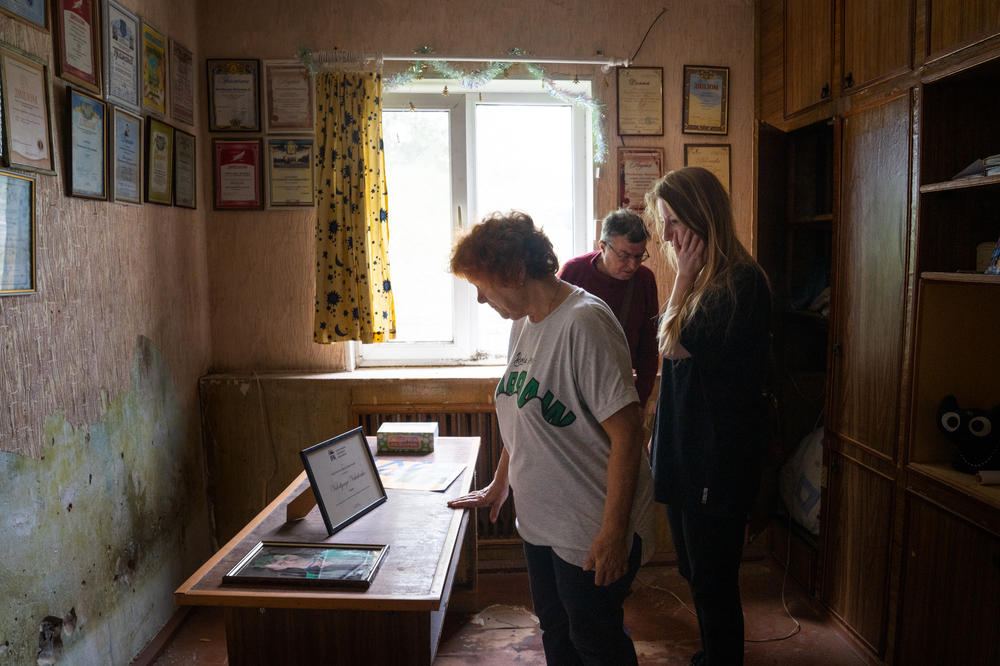 Amelina stands with the parents of Volodymyr Vakulenko in a room that memorializes his life.