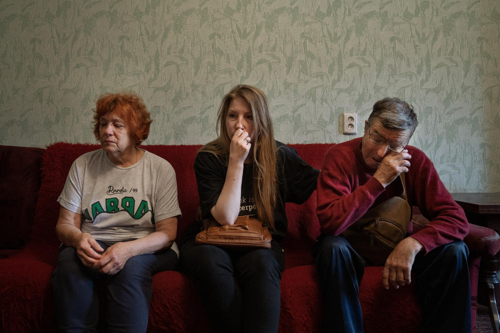 Amelina sits with Vakulenko's parents, his mother Olena Ihnatenko (left) and his father, who shares his name. They tear up every time the speak about their son.