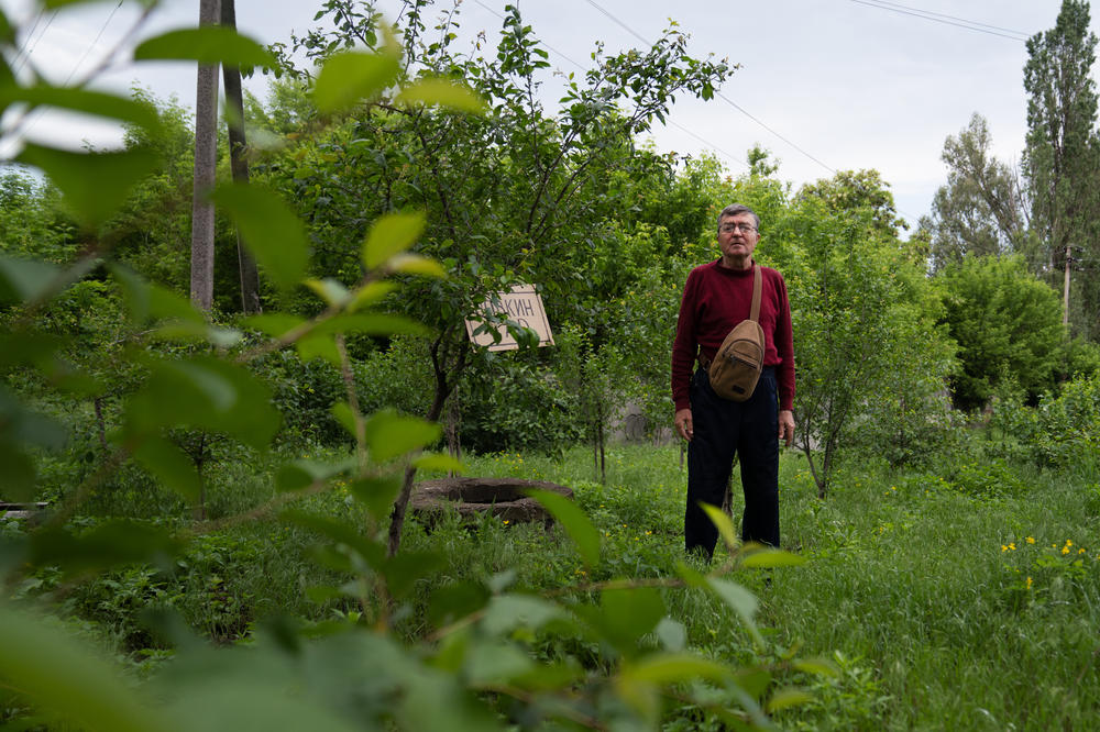 The older Volodymyr Vakulenko stands in a garden dedicated to his son with the same name, near his home in Kapytolivka.