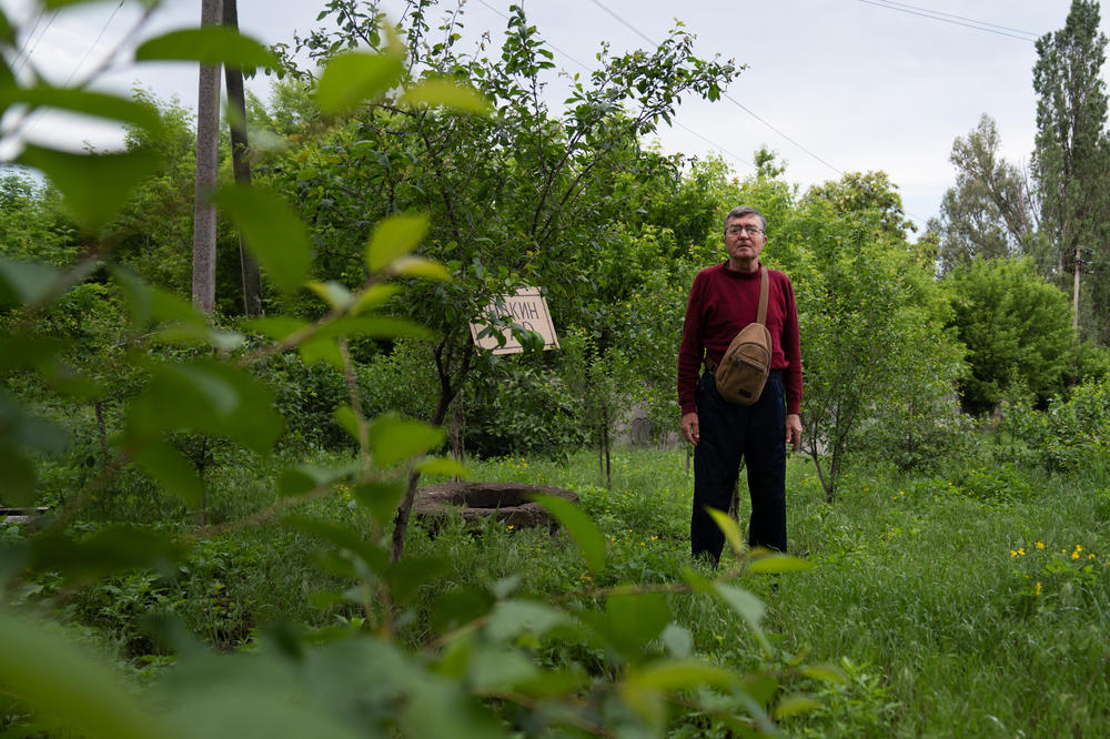 The older Volodymyr Vakulenko stands in a garden dedicated to his son with the same name, near his home in Kapytolivka.
