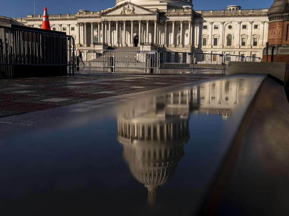 The Dome of the U.S. Capitol Building is visible in a reflection on Capitol Hill on Jan. 23, 2023.