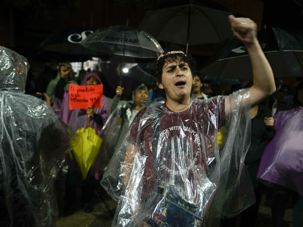 Protesters gather in front of the Supreme Electoral Tribunal building in Guatemala City, Wednesday. The tribunal certified presidential election results, sending candidates Sandra Torres and Bernardo Arévalo to an Aug. 20 runoff, while the Attorney General's Office announced that Arévalo's party had been suspended.