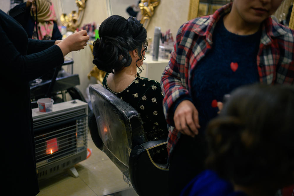 A Taliban edict issued this month will shutter some 3,000 women-run salons in Kabul. Above: A young woman visits a a beauty salon in Kabul to prepare for a wedding party. A ministry spokesman said the reason for the ban was that Afghan men are pressured to go into debt to pay for wedding makeovers for brides and their womenfolk.