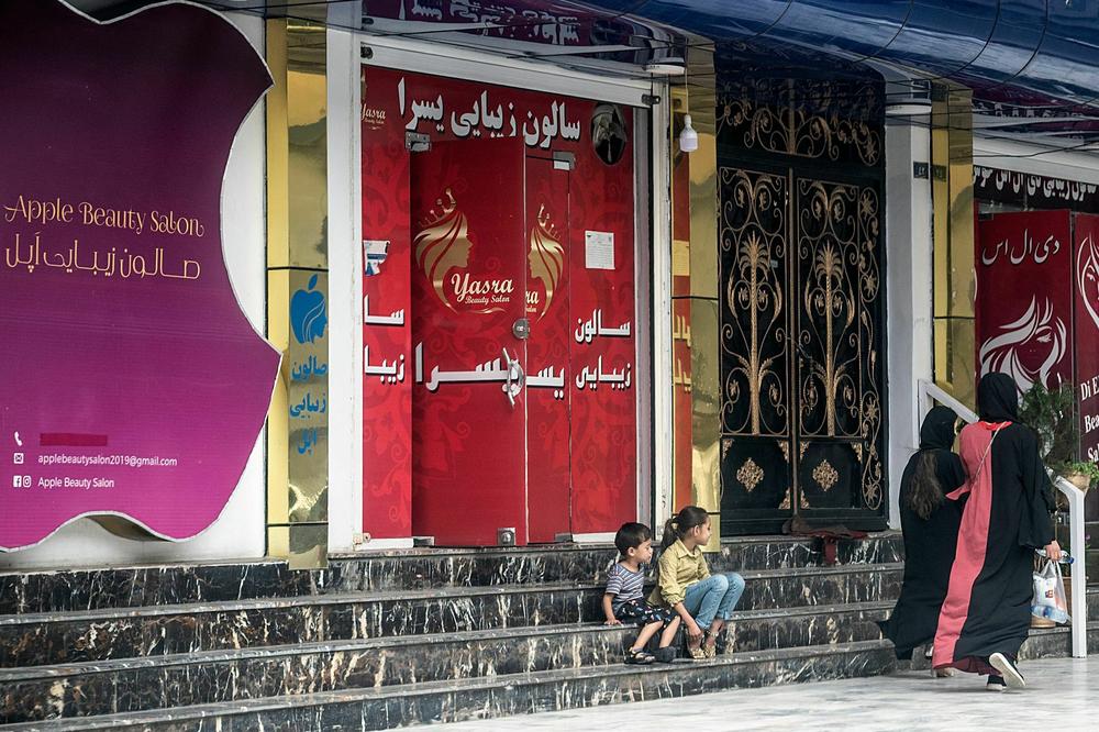 A beauty salon in Kabul. After the Taliban took power in 2021, salon owners were ordered to cover up shopfront images of women's faces adorned with eyeshadow and fake lashes — an anathema to the Taliban, who demand women and girls envelope themselves in black robes, including their faces.
