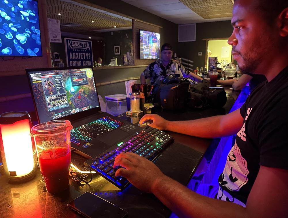 Nico Westley, 30, drinks raspberry hibiscus kratom tea while gaming at Kavasutra in Lantana, Fla. He says kratom makes him 