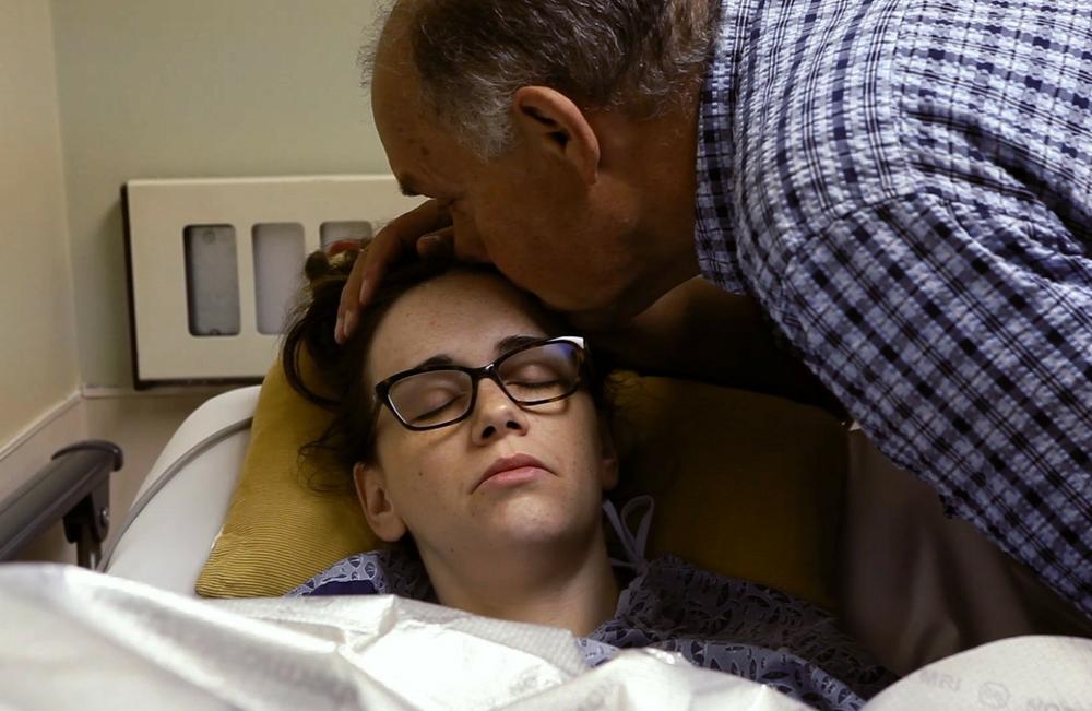 A still from <em>Below the Belt</em> shows Laura Cone of Saskatchewan, Canada with her father. She had four ablation surgeries with general OB/GYNs, but her condition kept deteriorating, until she found a surgeon who did excision surgery.