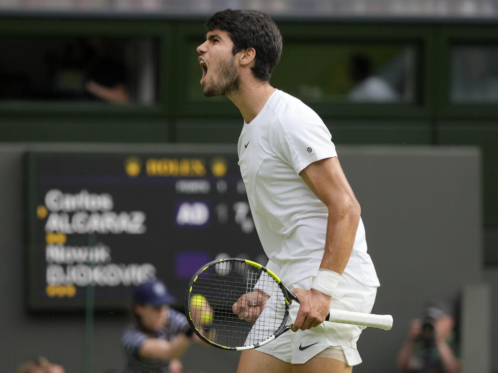 Spain's Carlos Alcaraz celebrates after winning a point against Serbia's Novak Djokovic in the final of the men's singles on day fourteen of the Wimbledon tennis championships in London on Sunday.
