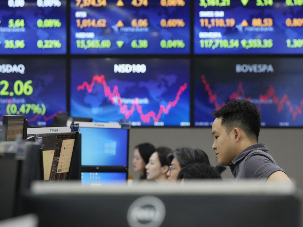A currency trader watches monitors at the foreign exchange dealing room of the KEB Hana Bank headquarters in Seoul, South Korea, Monday, July 17, 2023. Asian shares were mostly lower on Monday after China reported weaker growth than forecast in the last quarter.
