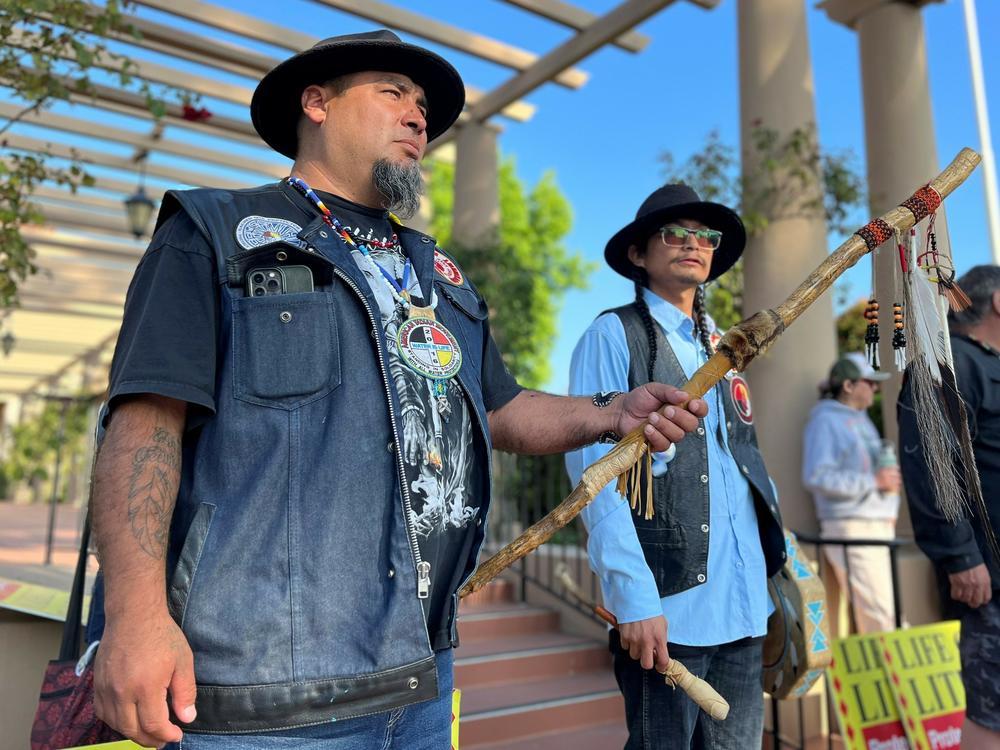 Josh Dini and Gary McKinney protest a planned lithium mine outside a federal appeals court in California in June.