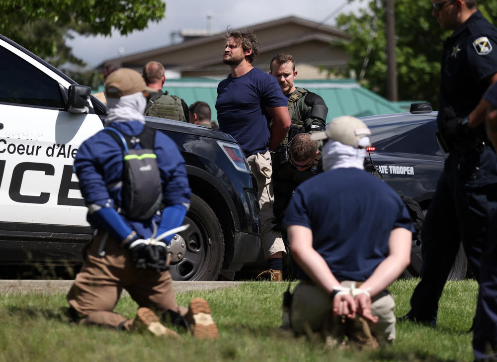 Law enforcement detains and arrest 31 members of the white nationalist group Patriot Front on suspicion of conspiracy to riot after they were removed from a U-Haul truck near the LGBTQ community's Pride in the Park event in Coeur d'Alene, Idaho, last June.