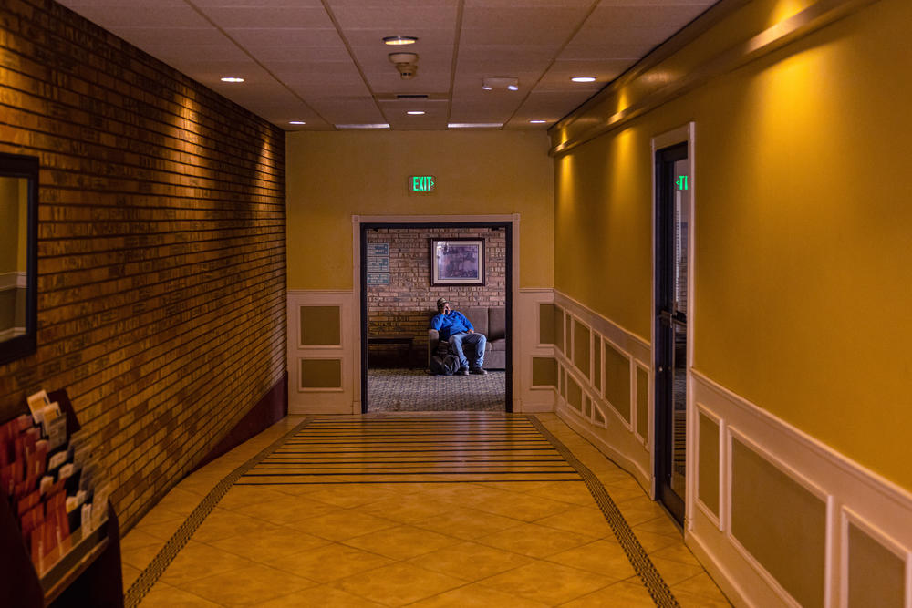 A man talks on a phone at the FairBridge Inn in Yakima, Wash., on June 26.
