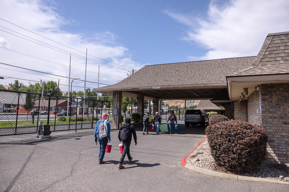 At the end of a workday in the fields, guest workers return to their housing at the FairBridge Inn in Yakima, Wash., on June 26, 2023.