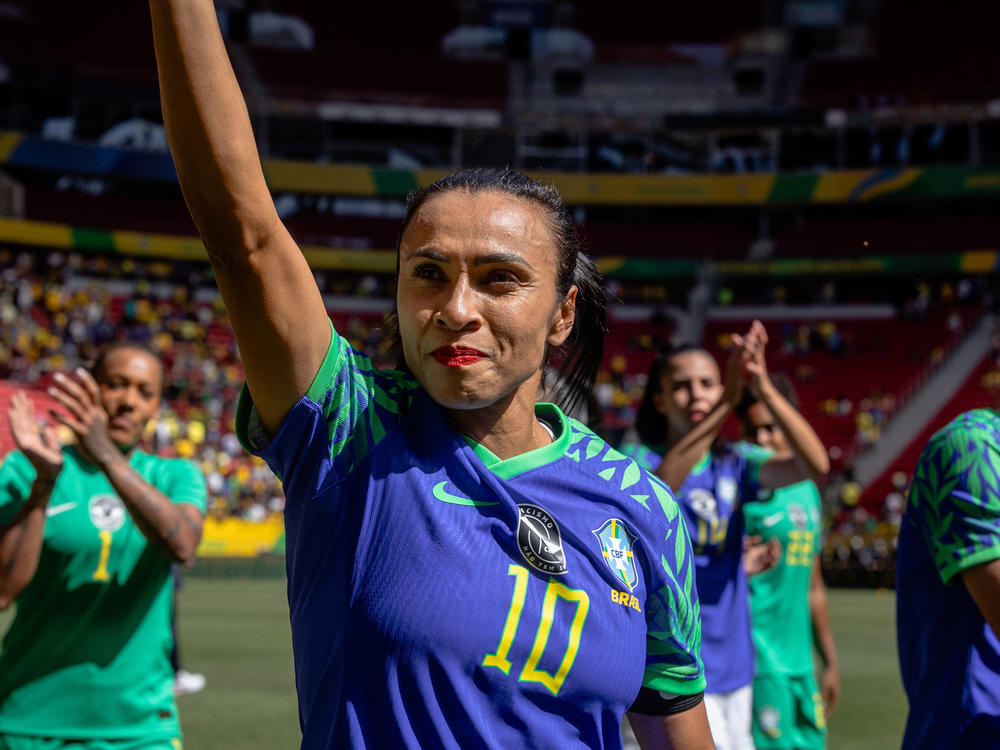 Marta and the Brazilian women's soccer team walk around the field greeting fans after a friendly match against Chile ahead of the World Cup, in Brasília, Brazil, on July 2.