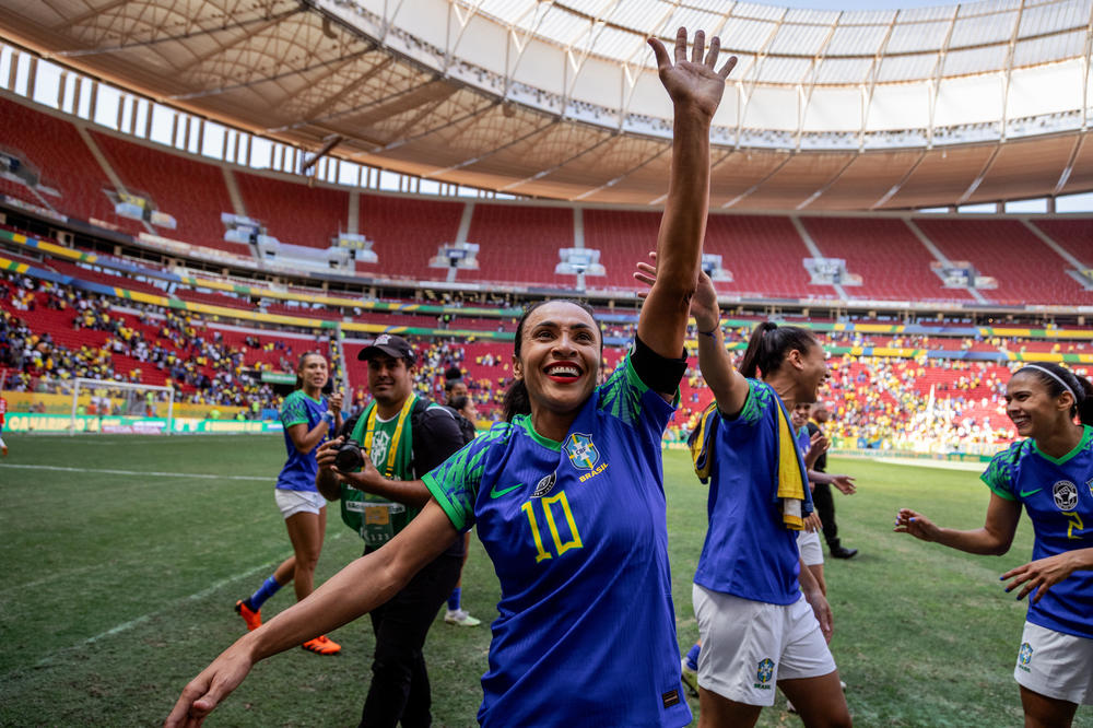 Marta and the Brazilian women's soccer team walk around the field greeting fans after a friendly match against Chile ahead of the World Cup, in Brasília, Brazil, on July 2.