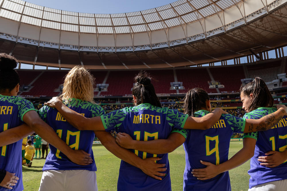 Marta and the Brazilian women's soccer team sing the national anthem before a friendly game against Chile ahead of the World Cup, in Brasília, Brazil, on July 2.