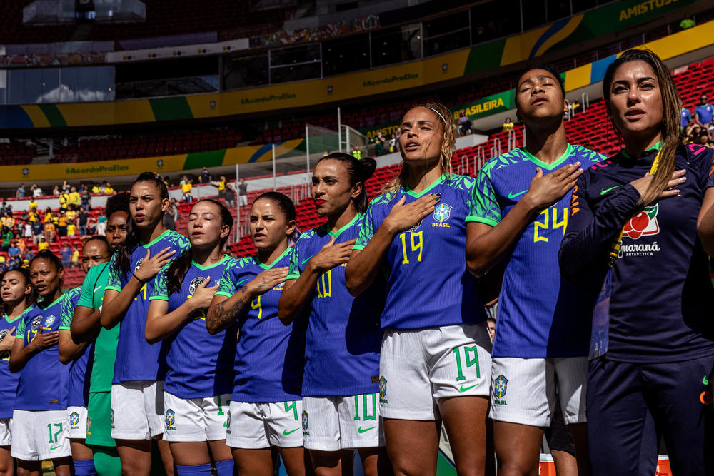 Marta and the Brazilian women's soccer team sing the national anthem before a friendly game against Chile ahead of the World Cup, in Brasília, Brazil, on July 2.
