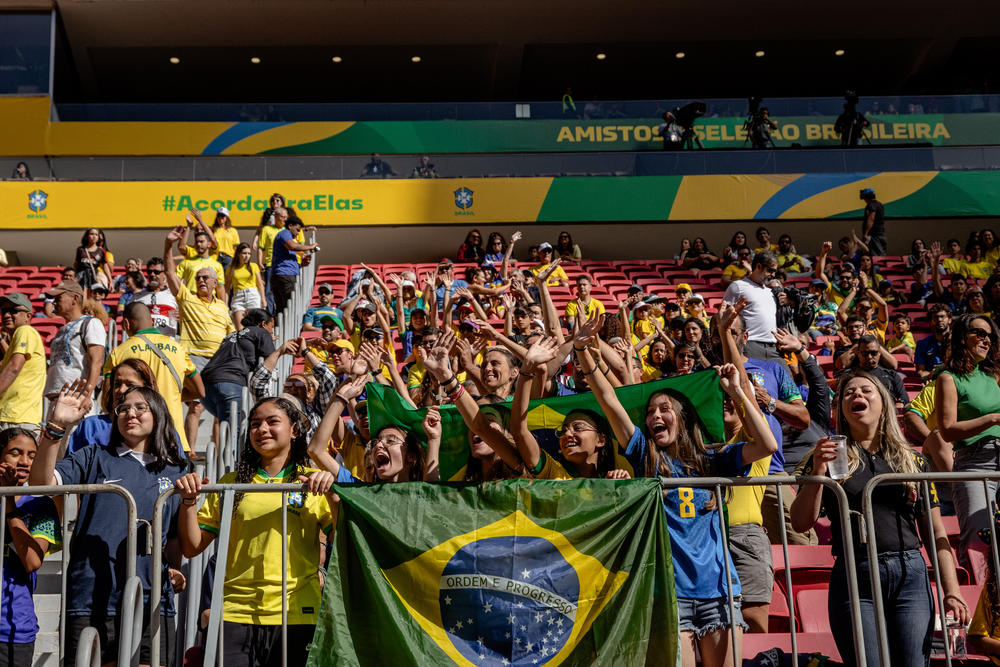 Fans cheer on Brazil's national women's soccer team as they enter field to warm up before a friendly game against Chile ahead of the World Cup, in Brasília, Brazil, on July 2.