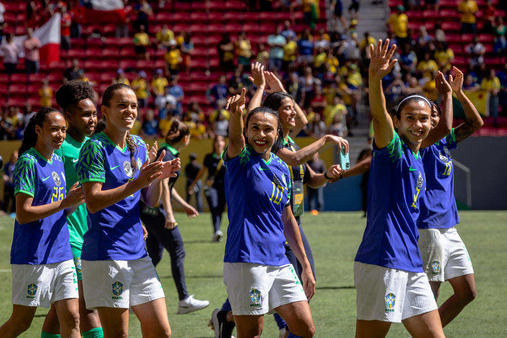 Marta and the Brazilian women's soccer team walk around the field greeting fans after a friendly match against Chile ahead of the World Cup, in Brasília, Brazil, on July 2.