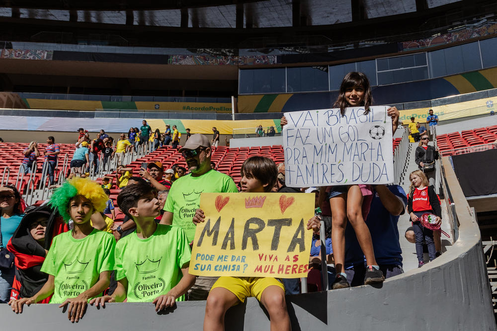 Fans arrive to cheer on Brazil's national women's soccer team as they enter the field to warm up before a friendly game against Chile ahead of the World Cup, in Brasília on July 2.