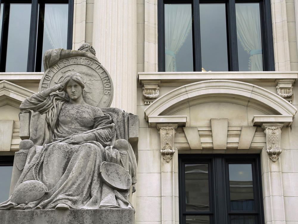 The Illinois Supreme Court on Tuesday upheld the constitutionality of a state law ending cash bail, ordering implementation in mid-September. Here, in this August 2014 photo shows a statue outside of the Illinois Supreme Court building in Springfield, Ill.