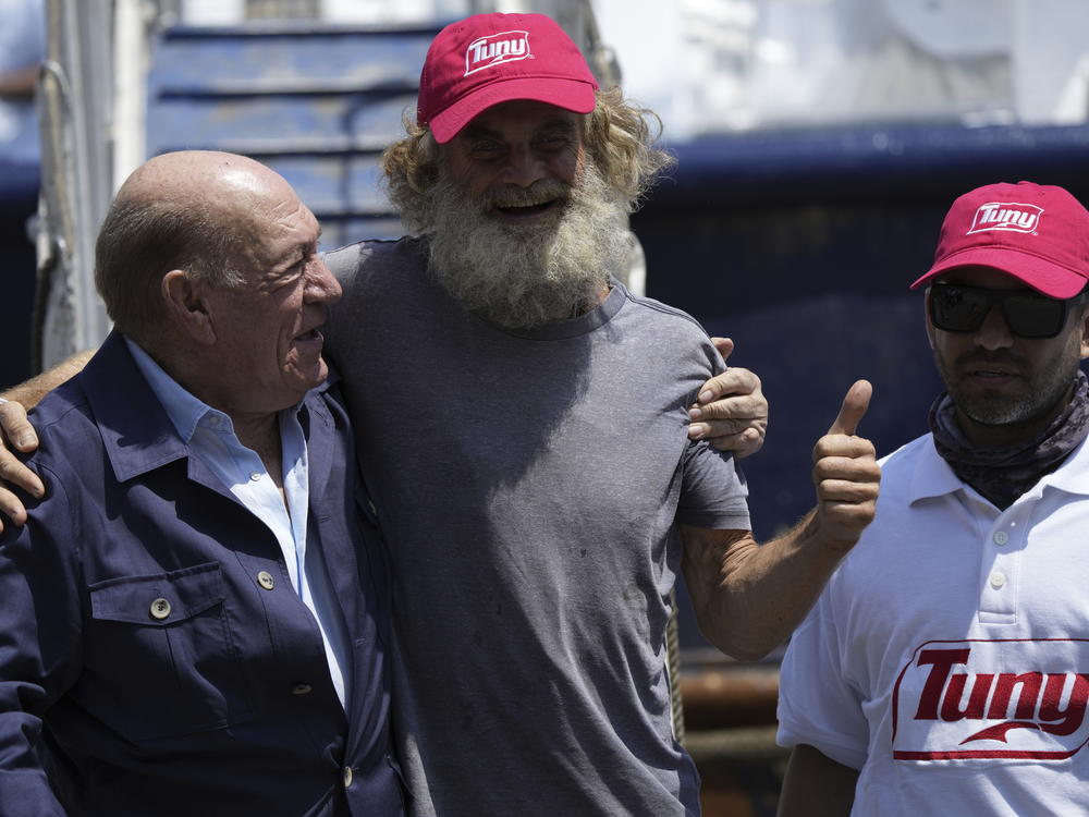 Australian Timothy Lyndsay Shaddock gives a thumbs up during a welcoming ceremony with Grupo Mar President Antonio Suarez, left, and Oscar Meza Oregó, captain of the Mexican tuna boat 