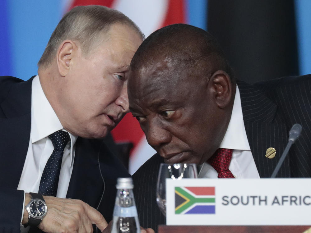 Russian President Vladimir Putin (left) speaks to South African President Cyril Ramaphosa during a plenary session at the Russia-Africa summit in the Black Sea resort of Sochi, Russia, on Oct. 24, 2019.