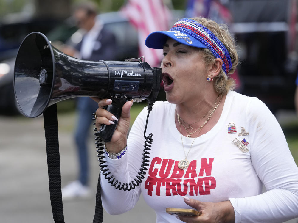 A supporter of former President Donald Trump speaks into a megaphone as supporters gather in Tropical Park in Miami, to convoy to his Mar-A-Lago club in Palm Beach, Fla., June 11.