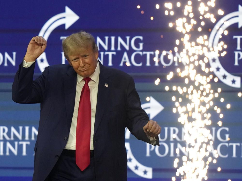 Former President Donald Trump dances on stage at the Turning Point Action conference on July 15.