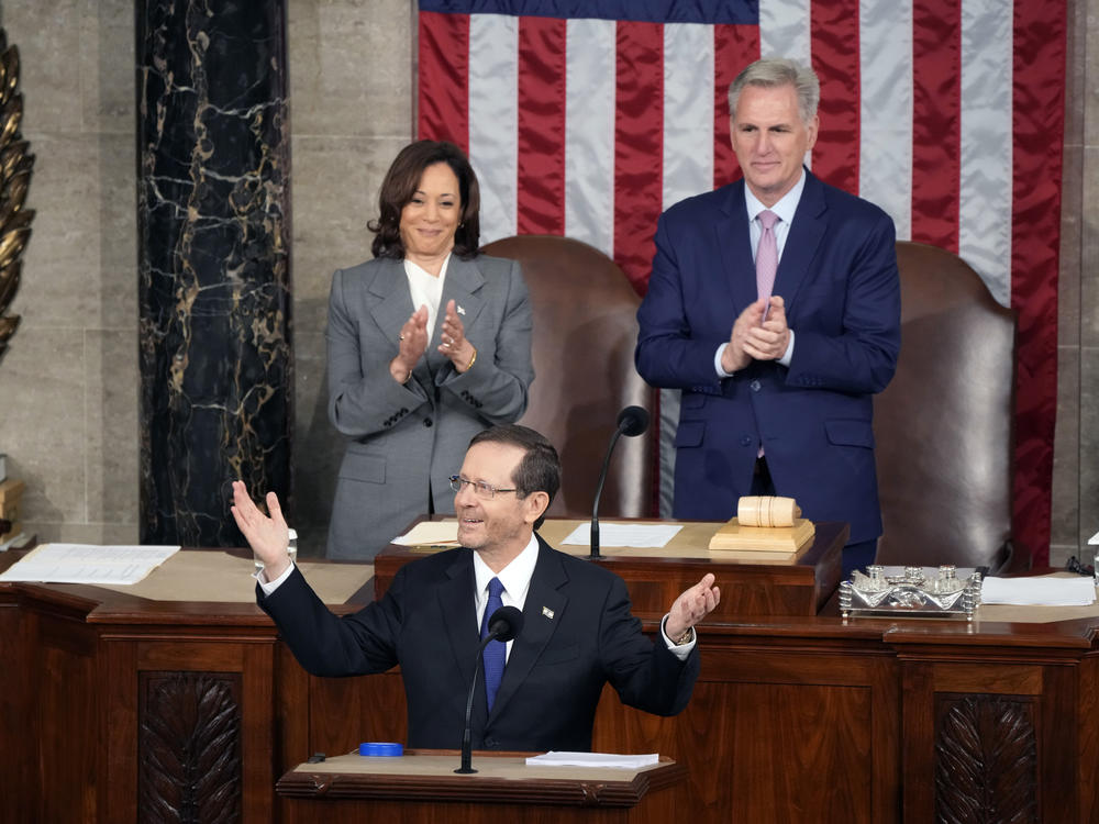 Israeli President Isaac Herzog arrives to speak to a joint meeting of Congress on Wednesday morning at the Capitol in Washington, as Vice President Kamala Harris and House Speaker Kevin McCarthy of Calif., look on.