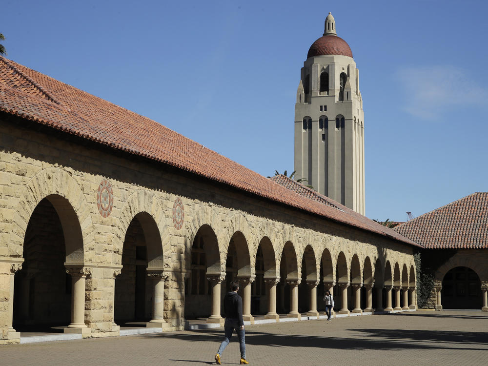 People walk on the Stanford University campus beneath Hoover Tower in Stanford, Calif., on March 14, 2019. Stanford President Marc Tessier-Lavigne said on Wednesday he would resign, citing an independent review that cleared him of research misconduct but found flaws in other papers authored by his lab.
