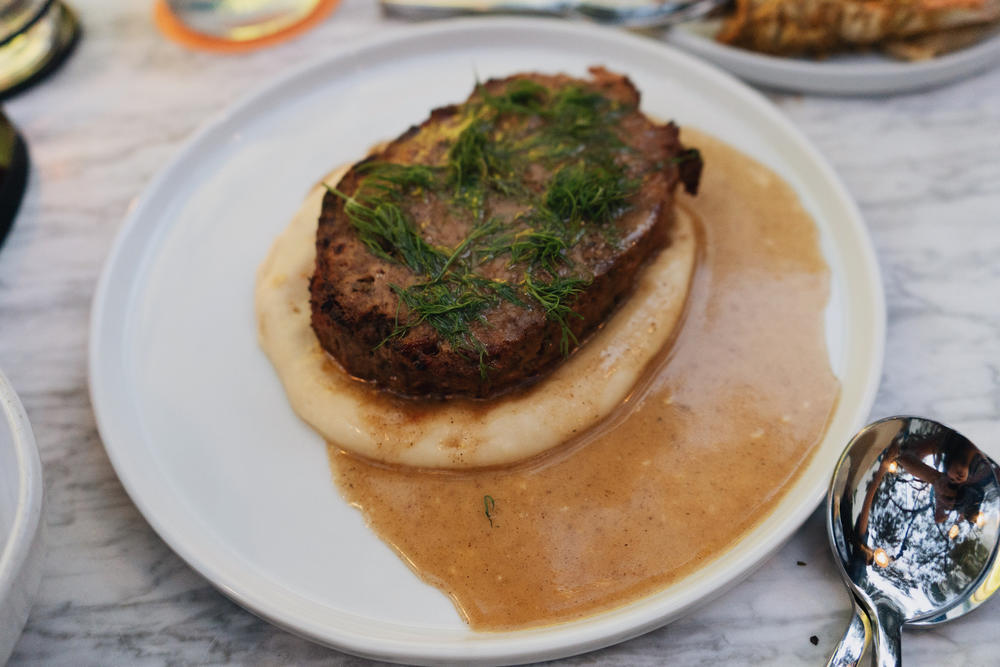 American chef Andrew Zimmern's grandmother's meatloaf sits atop mashed potatoes and gravy.