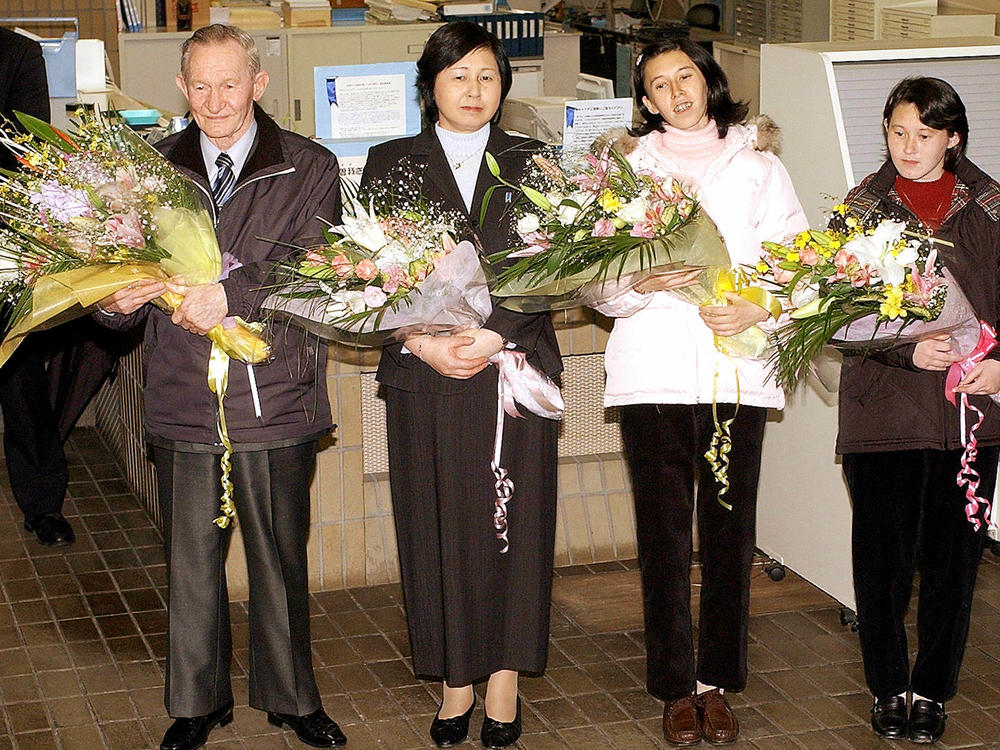 Charles Jenkins (left), age 64, his wife Hitomi Soga (second from left) and their daughters arrive at Japan's Sado Island in December 2004, almost 40 years after he defected to North Korea.